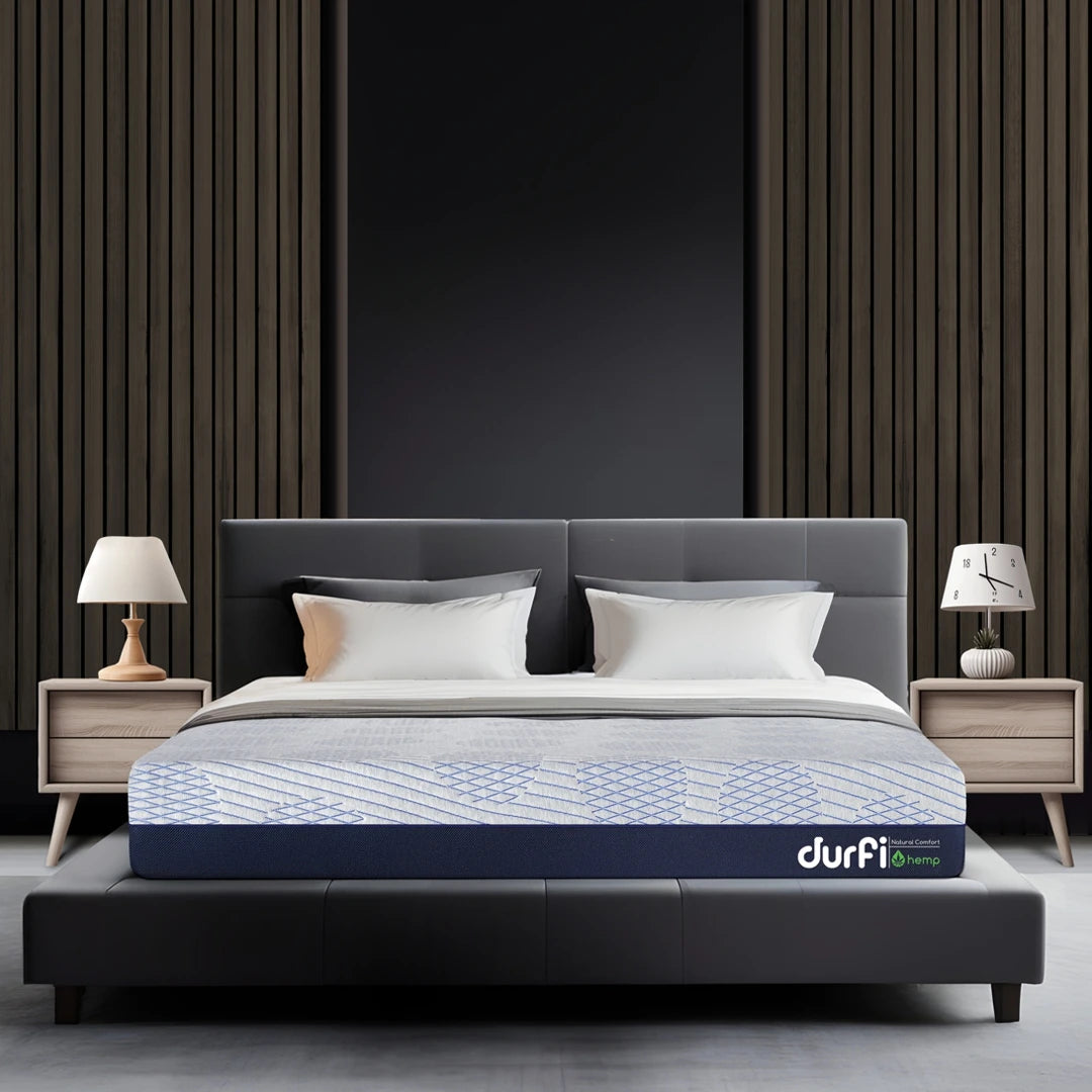 Durfi Hemp Hempseed Oil Mattress placed on a dark upholstered bed frame in a modern bedroom with slatted wood wall panel and matching wooden nightstands