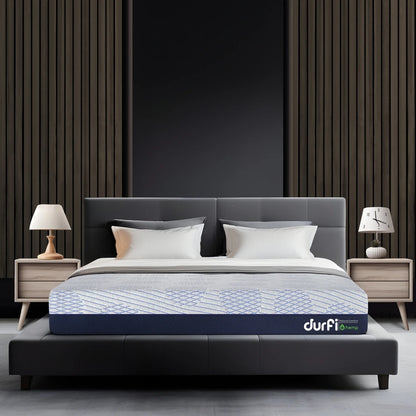 Durfi Hemp Hempseed Oil Mattress placed on a dark upholstered bed frame in a modern bedroom with slatted wood wall panel and matching wooden nightstands