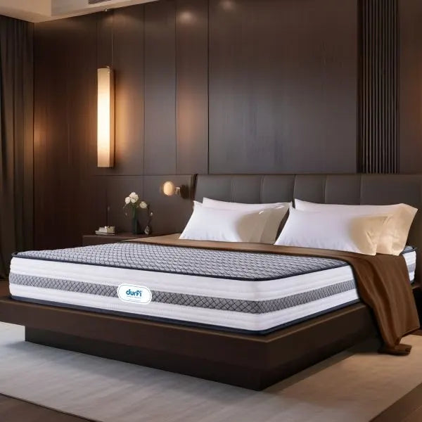 Durfi Ortho Memory Foam Mattress shown at an angle on a low-profile dark wood bed frame in a contemporary bedroom setting
